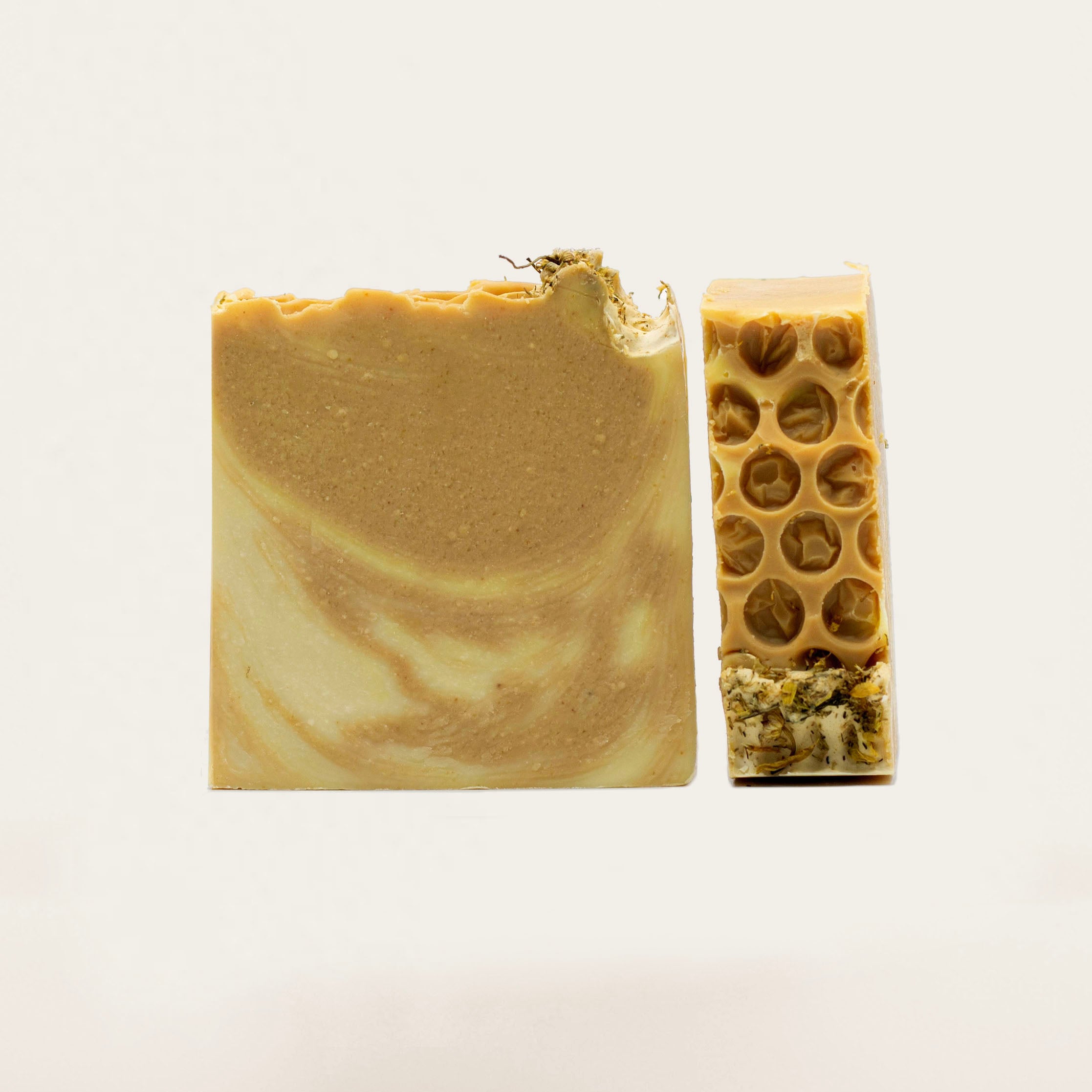 Amber Organic Soap bars with a swirl pattern and honeycomb detailing, made with carrot, turmeric, and honey for nourished and radiant skin. Topped with yarrow flowers, 90 g (3.17 oz)