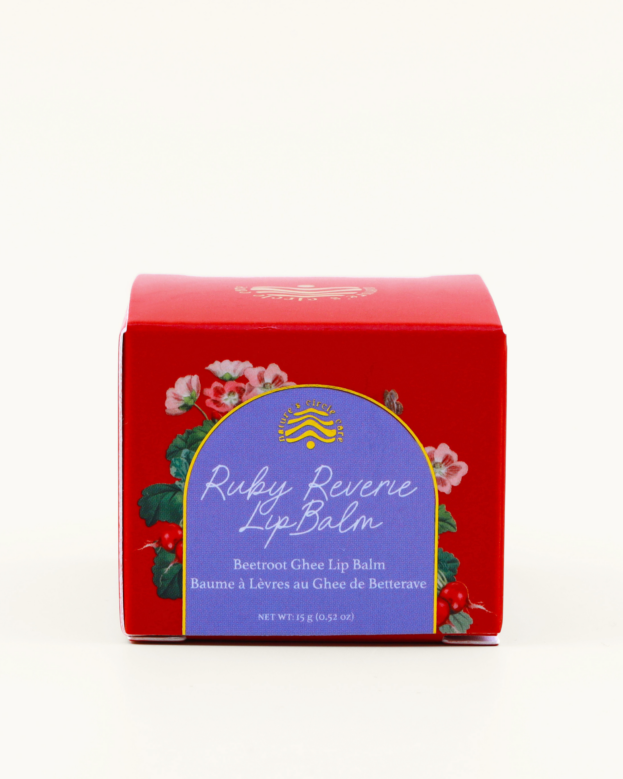 Ruby Reverie (Beetroot Ghee Lip Balm) by Nature's Circle Care red and blue packaging with botanical and bright design on a white background.