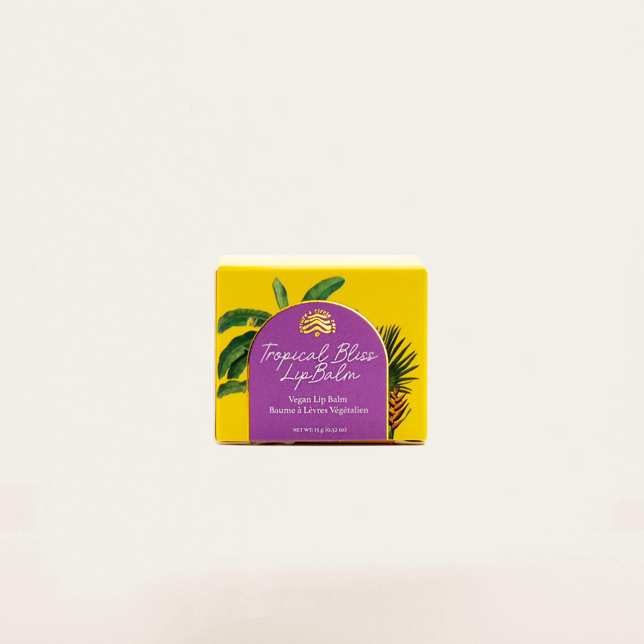 Vegan Tropical Bliss Lip Balm with a blend of natural oils, refined shea butter, and coconut & peaches flavor for a tropical touch.