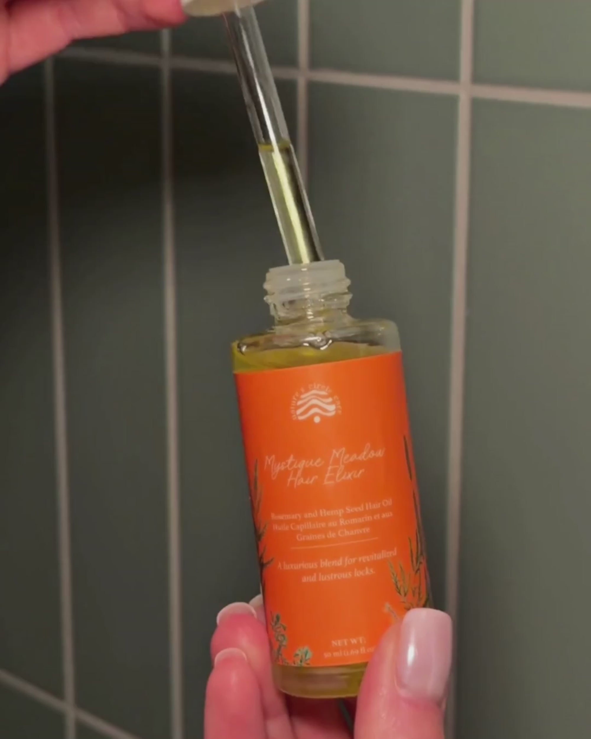 Application of Mystique Meadow Hair Elixir to strengthen, nourish, and grow hair.